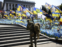 A Ukrainian serviceman commemorates his brothers-in-arms at a makeshift memorial for fallen Ukrainian soldiers on the Day of Remembrance of...