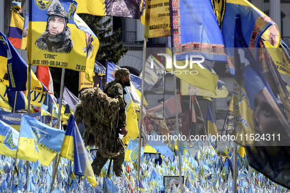 A Ukrainian serviceman commemorates his brothers-in-arms at a makeshift memorial for fallen Ukrainian soldiers on the Day of Remembrance of...