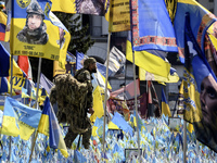 A Ukrainian serviceman commemorates his brothers-in-arms at a makeshift memorial for fallen Ukrainian soldiers on the Day of Remembrance of...