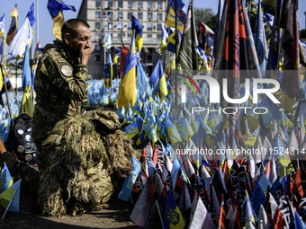 A Ukrainian serviceman commemorates his brothers-in-arms at a makeshift memorial for fallen Ukrainian soldiers on the Day of Remembrance of...