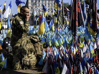 A Ukrainian serviceman commemorates his brothers-in-arms at a makeshift memorial for fallen Ukrainian soldiers on the Day of Remembrance of...