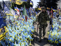 A Ukrainian serviceman commemorates his brothers-in-arms at a makeshift memorial for fallen Ukrainian soldiers on the Day of Remembrance of...