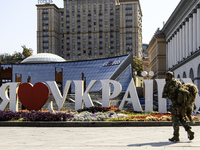 A Ukrainian serviceman commemorates his brothers-in-arms at a makeshift memorial for fallen Ukrainian soldiers on the Day of Remembrance of...