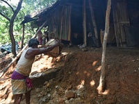 People stand in their broken house by flood water in Feni District, Bangladesh, on August 29, 2024. At least 52 people are killed, a total o...