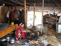 A woman cooks in her broken house due to flood water in Feni District, Bangladesh, on August 29, 2024. At least 52 people are killed, a tota...