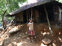 People stand in their broken house by flood water in Feni District, Bangladesh, on August 29, 2024. At least 52 people are killed, a total o...