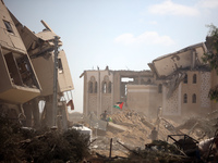 Palestinians collect their belongings and inspect the destruction caused by Israeli airstrikes in eastern Deir al-Balah in central Gaza Stri...