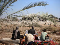 Palestinians collect their belongings and inspect the destruction caused by Israeli airstrikes in eastern Deir al-Balah in central Gaza Stri...