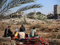 Palestinians collect their belongings and inspect the destruction caused by Israeli airstrikes in eastern Deir al-Balah in central Gaza Stri...