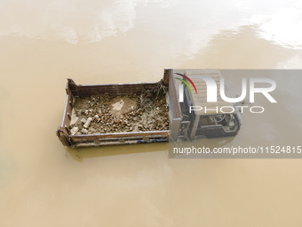 A car is half submerged in the flood water in Chanpur area of Chagalnaia upazila of Feni district in Chittagong division, Bangladesh, on Aug...