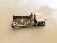 A car is half submerged in the flood water in Chanpur area of Chagalnaia upazila of Feni district in Chittagong division, Bangladesh, on Aug...