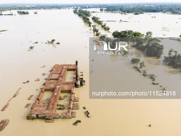 A brickyard and a car are half submerged in flood water in the Chanpur area of Chagalnaia upazila of Feni district of Chittagong division of...