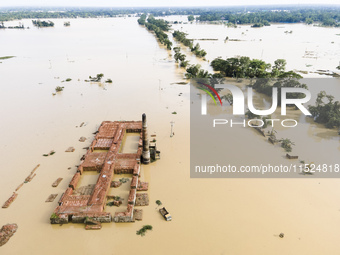 A brickyard and a car are half submerged in flood water in the Chanpur area of Chagalnaia upazila of Feni district of Chittagong division of...