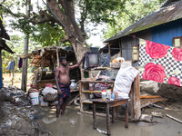 A man tries to collect damaged and scattered items in flood waters in the Gopal area of Chagalnaia Upazila in Feni district of Chittagong di...