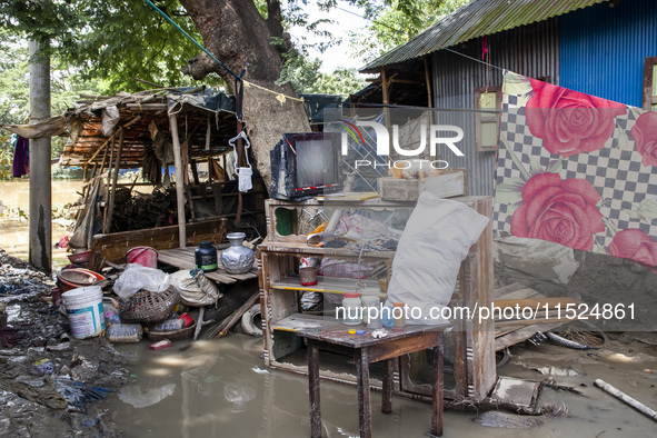 A family's flood-damaged belongings lie around the Gopal area of Chhagalnaiya upazila in Feni district of Chittagong division in Bangladesh....