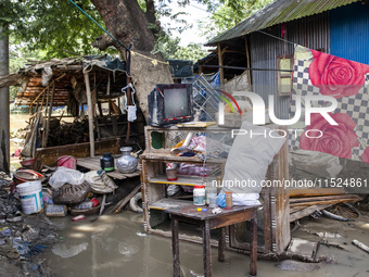 A family's flood-damaged belongings lie around the Gopal area of Chhagalnaiya upazila in Feni district of Chittagong division in Bangladesh....