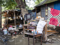 A family's flood-damaged belongings lie around the Gopal area of Chhagalnaiya upazila in Feni district of Chittagong division in Bangladesh....