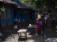 A flood-affected family places rice on a table to dry in the low sun in the Gopal area of Chagalnaya upazila, Feni district, Chittagong divi...