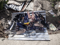 A flood-affected family puts their shoes on a tin to dry in the little sun in the Gopal area of Chagalnaiya upazila, Feni district, Chittago...