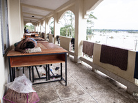 A person sleeps on a table on the balcony of a shelter in Chagalnaya Upazila, Feni District, Chittagong Division, Bangladesh, on August 29,...