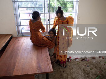 A few little girls stand by the window on the balcony of a shelter in Chagalnaya Upazila, Feni District, Chittagong Division, Bangladesh, on...