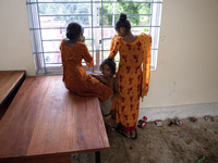 A few little girls stand by the window on the balcony of a shelter in Chagalnaya Upazila, Feni District, Chittagong Division, Bangladesh, on...