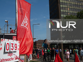 A thousand steel workers stand in front of the gate of the Thyssenkrupp industrial area in Duisburg, Germany, on August 29, 2024, as the IG...