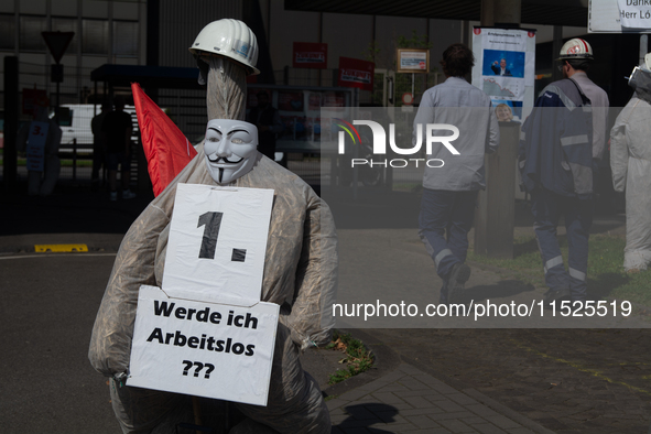 A dummy steelworker holds a sign reading ''Am I out of job?'' in front of the gate of the Thyssenkrupp industrial area in Duisburg, Germany,...