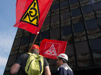 A thousand steel workers stand in front of the gate of the Thyssenkrupp industrial area in Duisburg, Germany, on August 29, 2024, as the IG...