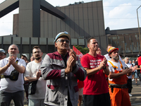 A thousand steel workers stand in front of the gate of the Thyssenkrupp industrial area in Duisburg, Germany, on August 29, 2024, as the IG...