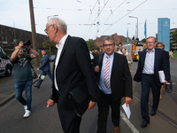 Sigmar Gabriel, the head of the supervisory board, comes toward the press conference site as a thousand steel workers stand in front of the...