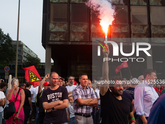 A thousand steel workers stand in front of the gate of the Thyssenkrupp industrial area in Duisburg, Germany, on August 29, 2024, as the IG...