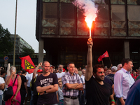 A thousand steel workers stand in front of the gate of the Thyssenkrupp industrial area in Duisburg, Germany, on August 29, 2024, as the IG...