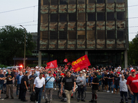 A thousand steel workers stand in front of the gate of the Thyssenkrupp industrial area in Duisburg, Germany, on August 29, 2024, as the IG...