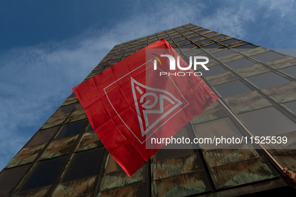 A general view of the IGM labor flag is seen in front of the Thyssenkrupp headquarters as a thousand steel workers stand in front of the gat...