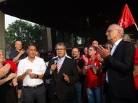 Sigmar Gabriel, the head of the supervisory board, speaks to the steelworkers after the press conference as a thousand steelworkers stand in...