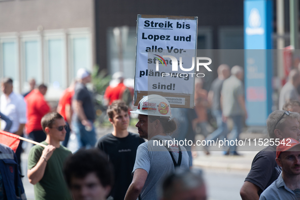 A thousand steel workers stand in front of the gate of the Thyssenkrupp industrial area in Duisburg, Germany, on August 29, 2024, as the IG...