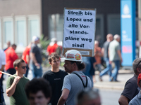 A thousand steel workers stand in front of the gate of the Thyssenkrupp industrial area in Duisburg, Germany, on August 29, 2024, as the IG...