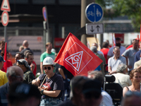 A thousand steel workers stand in front of the gate of the Thyssenkrupp industrial area in Duisburg, Germany, on August 29, 2024, as the IG...