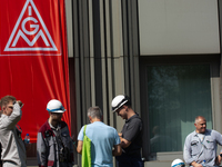 A thousand steel workers stand in front of the gate of the Thyssenkrupp industrial area in Duisburg, Germany, on August 29, 2024, as the IG...