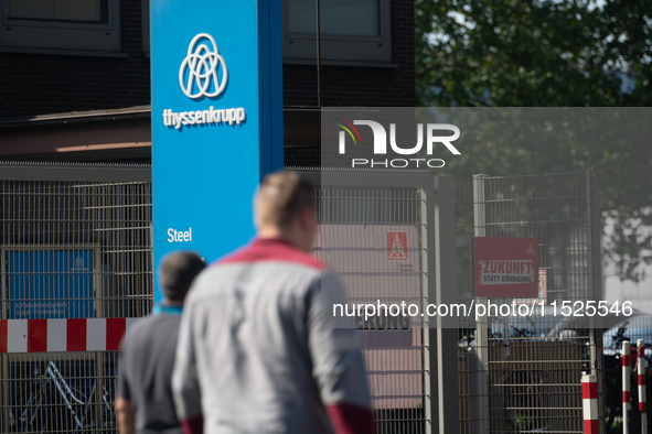 A thousand steel workers stand in front of the gate of the Thyssenkrupp industrial area in Duisburg, Germany, on August 29, 2024, as the IG...