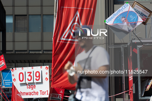 A thousand steel workers stand in front of the gate of the Thyssenkrupp industrial area in Duisburg, Germany, on August 29, 2024, as the IG...