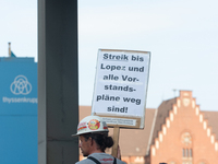 A thousand steel workers stand in front of the gate of the Thyssenkrupp industrial area in Duisburg, Germany, on August 29, 2024, as the IG...