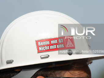 A thousand steel workers stand in front of the gate of the Thyssenkrupp industrial area in Duisburg, Germany, on August 29, 2024, as the IG...