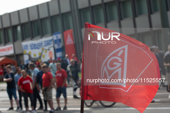 A thousand steel workers stand in front of the gate of the Thyssenkrupp industrial area in Duisburg, Germany, on August 29, 2024, as the IG...