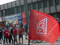 A thousand steel workers stand in front of the gate of the Thyssenkrupp industrial area in Duisburg, Germany, on August 29, 2024, as the IG...