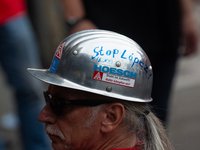 A thousand steel workers stand in front of the gate of the Thyssenkrupp industrial area in Duisburg, Germany, on August 29, 2024, as the IG...