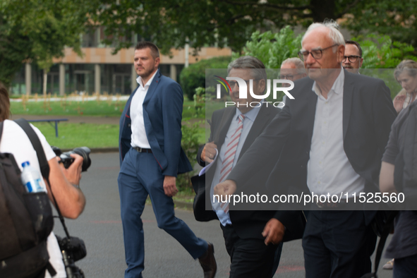 Sigmar Gabriel, the head of the supervisory board, comes toward the press conference site as a thousand steel workers stand in front of the...