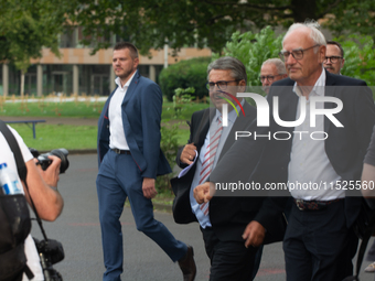 Sigmar Gabriel, the head of the supervisory board, comes toward the press conference site as a thousand steel workers stand in front of the...