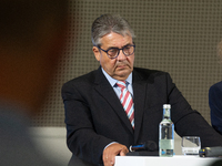 Sigmar Gabriel, the head of the supervisory board, comes toward the press conference site as a thousand steel workers stand in front of the...